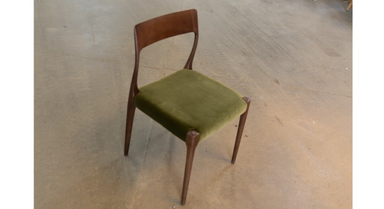 Scandinavian chair dark brown stained wood with green fabric seat.