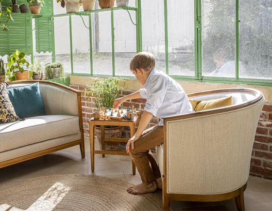 Antique armchair with moulded armrests wood stained antique and natural beige fabric