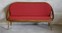 Scandinavian 2-seater sofa cherry wood stain and red fabric.