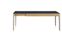 Extendable table for 8 to 12 people in oak and ceramic with ceramic extensions with natural stained wood and plain black ceramic top and extensions 160x100 cm
