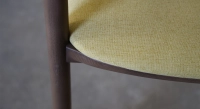 Scandinavian chair walnut wood with a pale yellow fabric seat