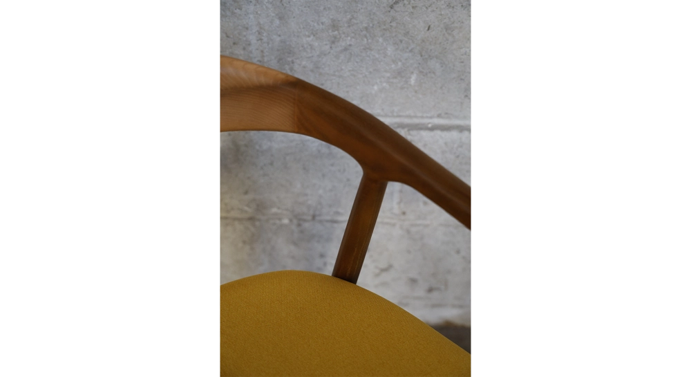 Scandinavian chair walnut wood with a pale yellow fabric seat