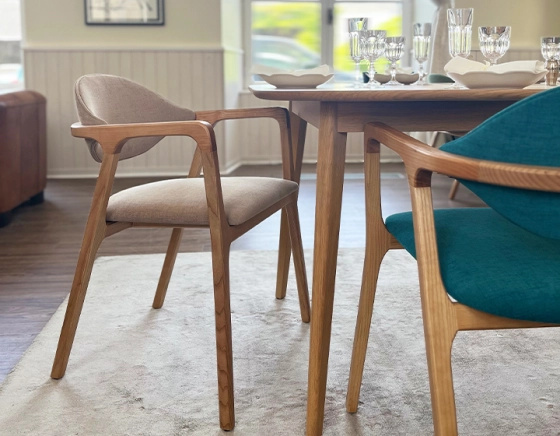 Designer chair with armrests natural wood stain and camel fabric