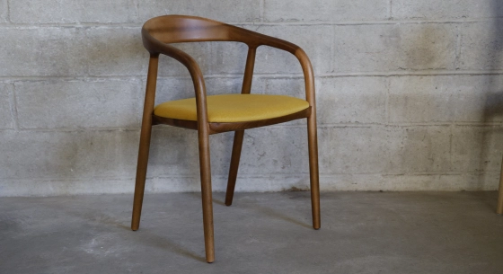 Scandinavian chair walnut wood with a pale yellow fabric seat