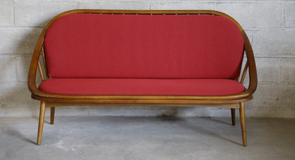Scandinavian 2-seater sofa cherry wood stain and red fabric.