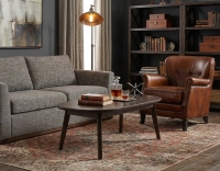 Fauteuil club cuir marron vintage accoudoirs cloutés