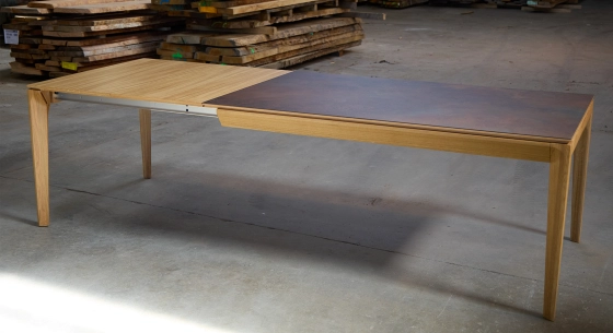 Extensible table for 6 to 10 people in oak and ceramic with wood extensions with natural wood finish and oxidized brown ceramic top. 160x100 cm