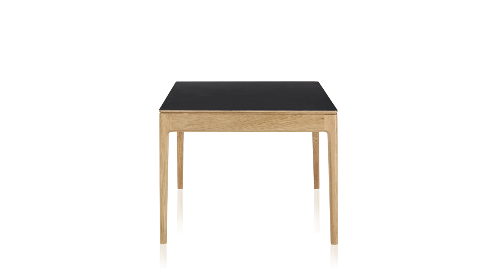 Extendable table for 8 to 12 people in oak and ceramic with ceramic extensions with natural stained wood and plain black ceramic top and extensions 180x100 cm