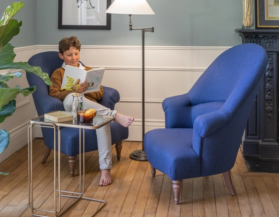 Fauteuil crapaud avec accoudoirs pieds bois teinte noyer et tissu bleu marine moyen dossier
