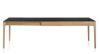 Extendable table for 8 to 12 people in oak and ceramic with ceramic extensions with natural stained wood and plain black ceramic top and extensions 180x100 cm
