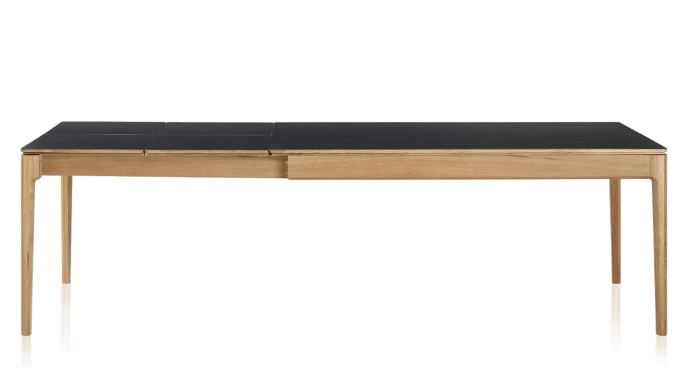 Extendable table for 8 to 14 people in oak and ceramic with ceramic extensions with natural stained wood and plain black ceramic top and extensions 210x100 cm