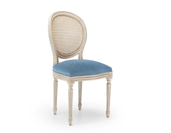 Louis XVI style antique chair wood with white cerused finish, caned backrest, and blue denim seat.