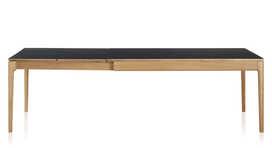 Extendable table for 8 to 12 people in oak and ceramic with ceramic extensions with natural stained wood and plain black ceramic top and extensions 180x100 cm