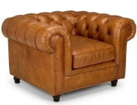 Sillón Chesterfield de piel cognac reposabrazos con tachuelas