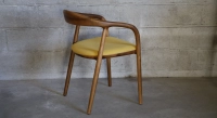 Scandinavian chair walnut wood with a pale yellow fabric seat