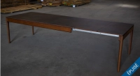 Extending table for 8 to 14 people in oak and ceramic with ceramic extensions with dark stained wood and a tabletop and extensions in oxidized brown ceramic. 210x100 cm Extending table for 8 to 14 people in oak and ceramic with ceramic extensions with dark stained wood and a tabletop and extensions in oxidized brown ceramic. 210x100 cm