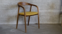 Scandinavian chair walnut wood with a pale yellow fabric seat