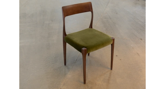 Scandinavian chair dark brown stained wood with green fabric seat.