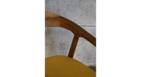 Scandinavian chair walnut wood with a pale yellow fabric seat