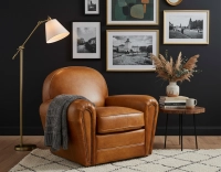 Fauteuil club cuir cognac accoudoirs cloutés