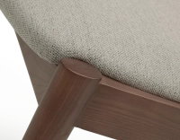 Walnut coloured design chair and natural beige fabric Walnut coloured design chair and natural beige fabric