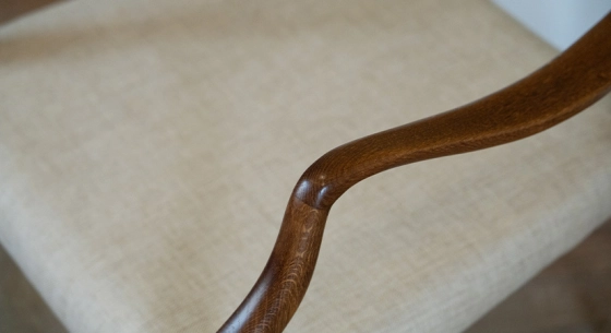 Armchairs dark brown stained wood and beige fabric